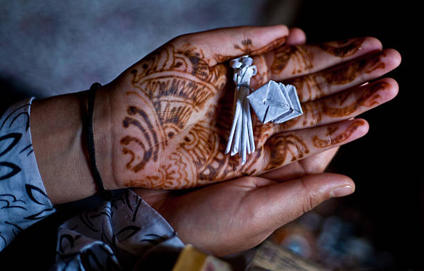 SRINAGAR, KASHMIR, INDIA - JULY 12: A Kashmiri Muslim woman hold  amulets in her hands given to her by a 'pir or dervish' ( local spiritual healer)  on July 12, 2012 in Srinagar, the summer capital of Indian Administered Kashmir. Known as the land of sufis and saints, following the outbreak of an armed rebellion against Indian rule  in 1989 , Kashmir has been in the grip of a bloody violence for more that past two decades.  More than 70,000 people have been killed, thousands have allegedly disappeared or been killed in custody of Indian forces with the conflict also rendering thousands of women widows and children orphans. The conflict has also taken a toll on Kashmir's collective physche, with doctors treating thousands of people for Post Traumatic Stress Disorder (PTSD) and other diseases related to mental depression and anxiety. Many Kashmiris, however, have turned to 'pirs or dervishes' ( local spritual healers) for solace. These Kashmiri peers or spiritual advisors provide solace and comfort to the patients with prayers and curative Quranic verses.  Muslims all over the world believe that the verses of Quran have healing properties. The spiritual healers also give people amulets.  (Photo by Yawar Nazir/Getty Images)